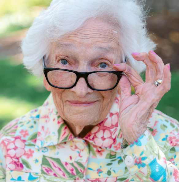 A woman holding her glasses
